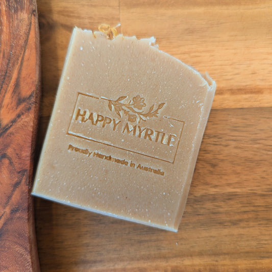 Bar of handmade Avocado aloe soap with 'Happy Myrtle' branding on a wooden surface